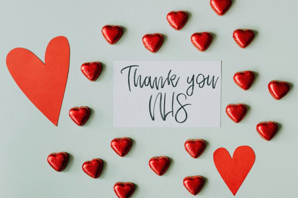 NHS IVF eligibility criteria illustrated by red hearts surrounding a sign saying 'Thank you NHS'