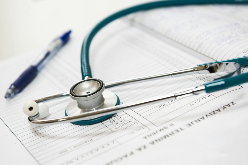 NHS IVF Success Rates, illustrated by a stethoscope and a pen on some printed data.